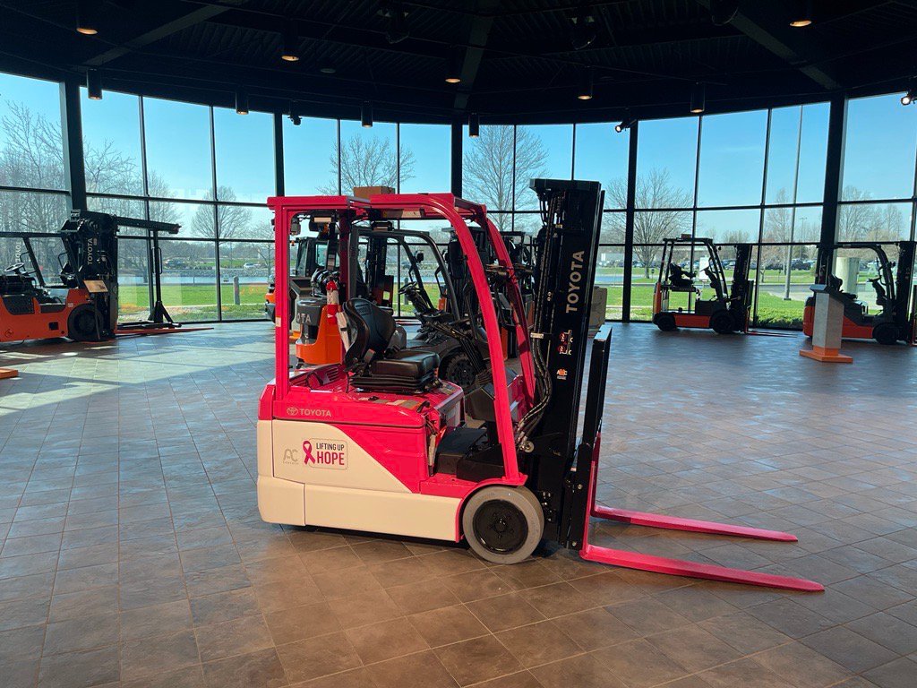 pink and white forklift designed and built to celebrate breast cancer awareness and Women's History Month