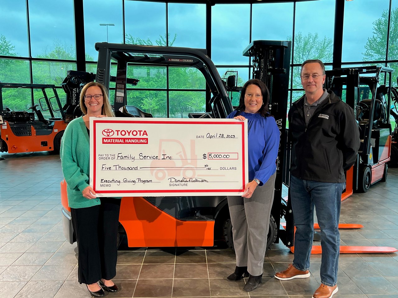 group photo holding check for Family Service, Inc. 