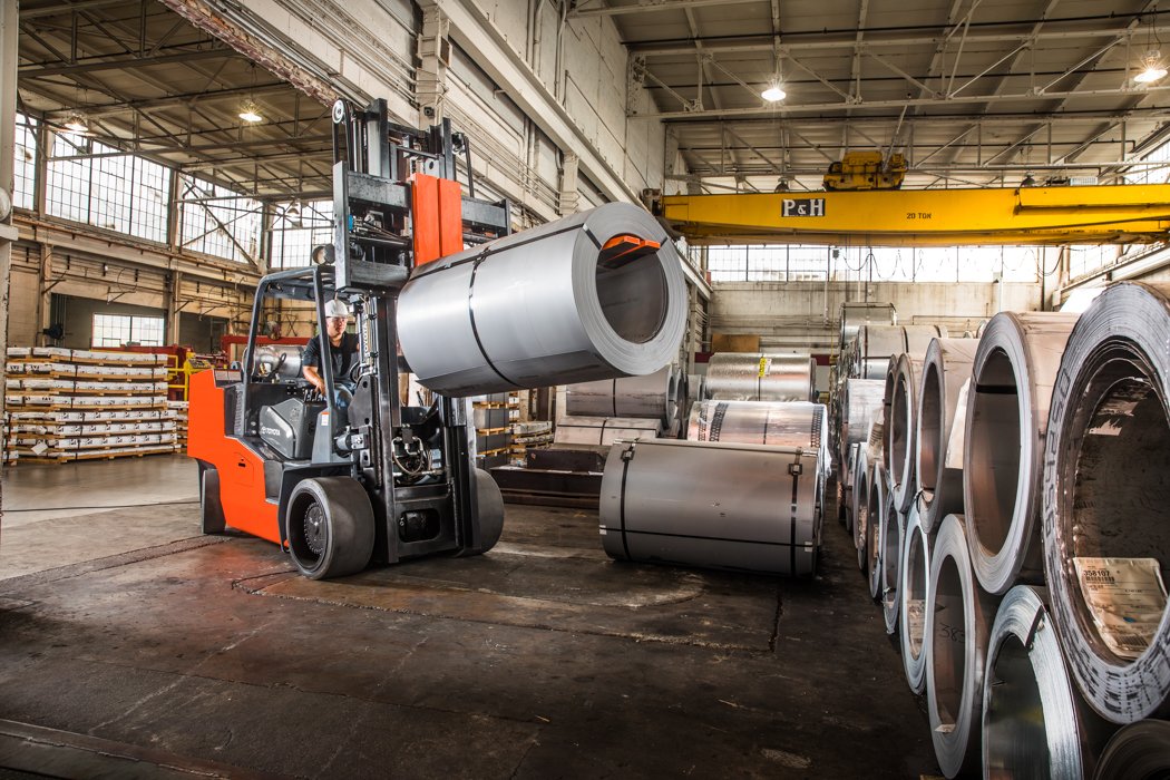 IC Cushion forklift is lifting roll of material in a warehouse 