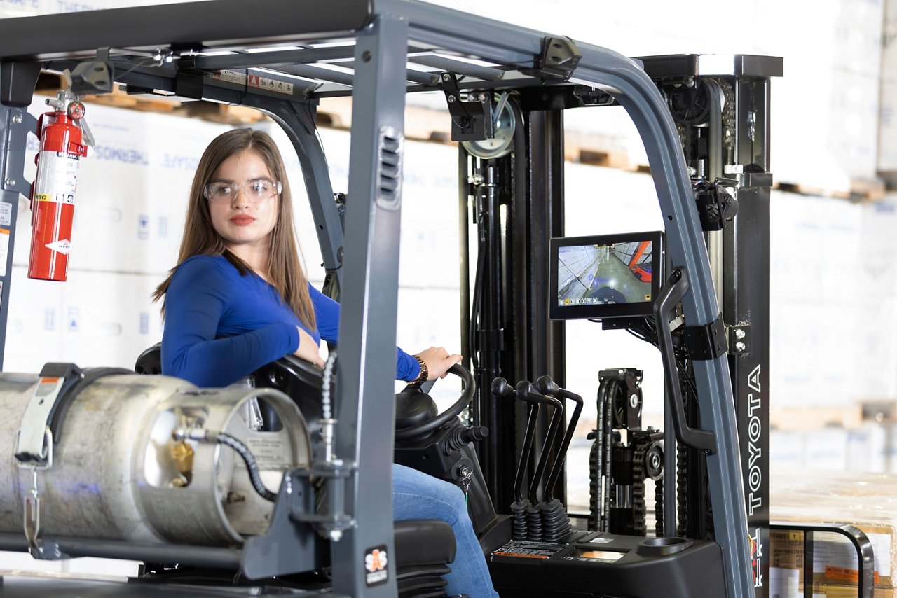 Close up of Woman driving Core IC Pneumatic and looking backwards to reverse