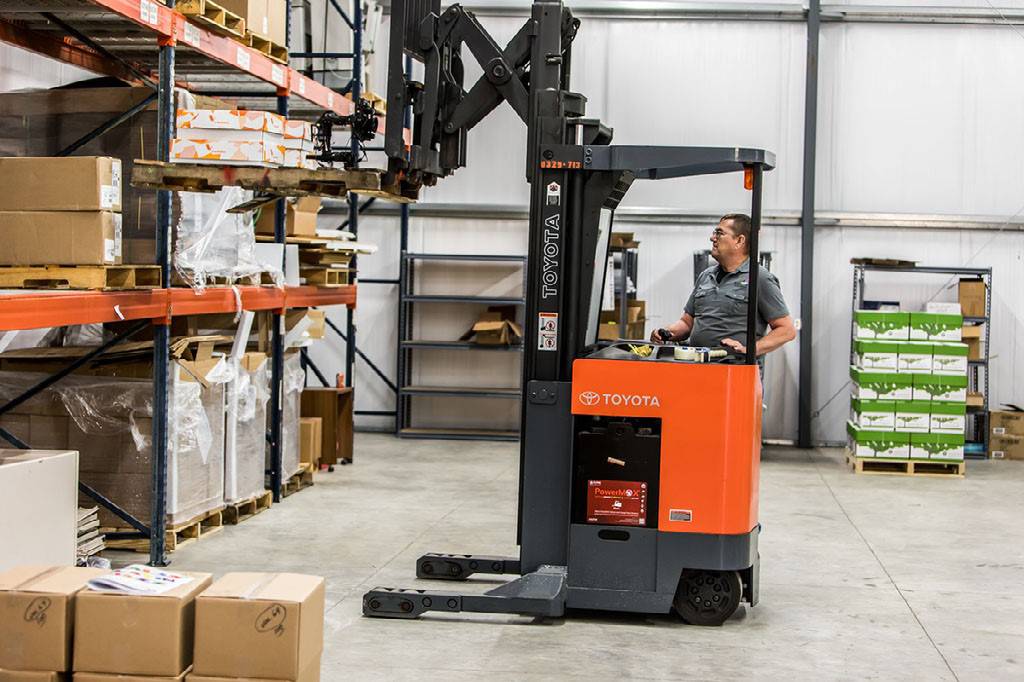 Man uses Toyota forklift in warehouse 