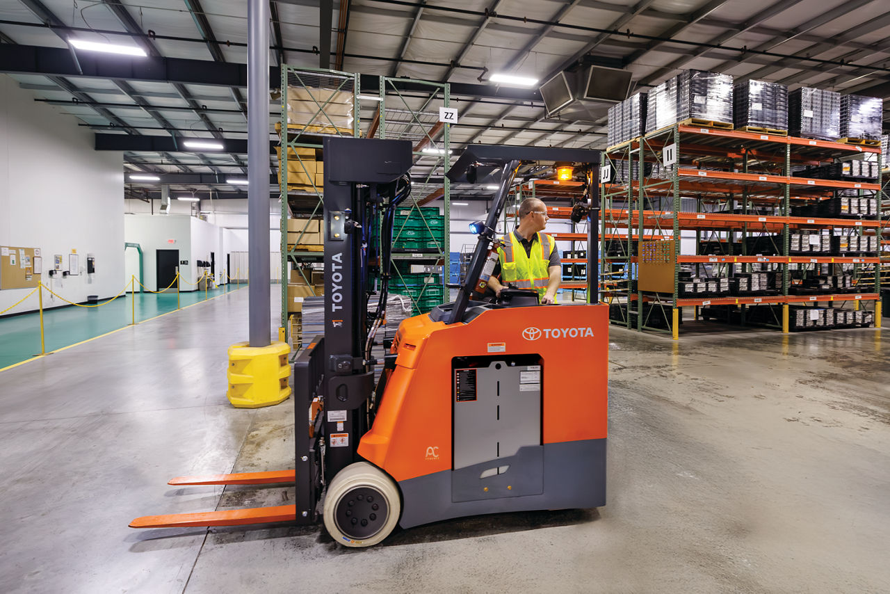 Electric forklift operating in an indoor warehouse for material handling