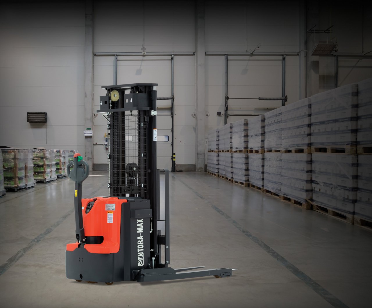 orange forklift stacker used in warehouse environment to load and unload products from point A to point B
