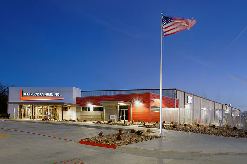 white and red building with the American Flag flying on a flag pole